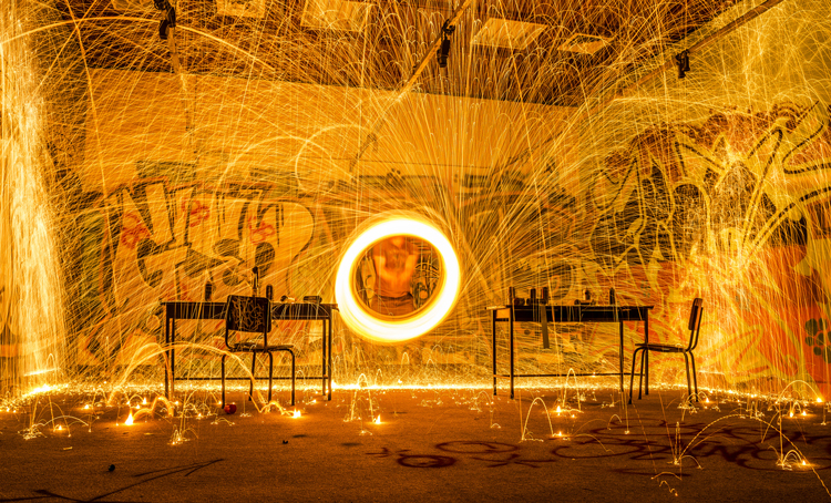 A circle of fire surrounding an office desk - (Photo by Dark Day)