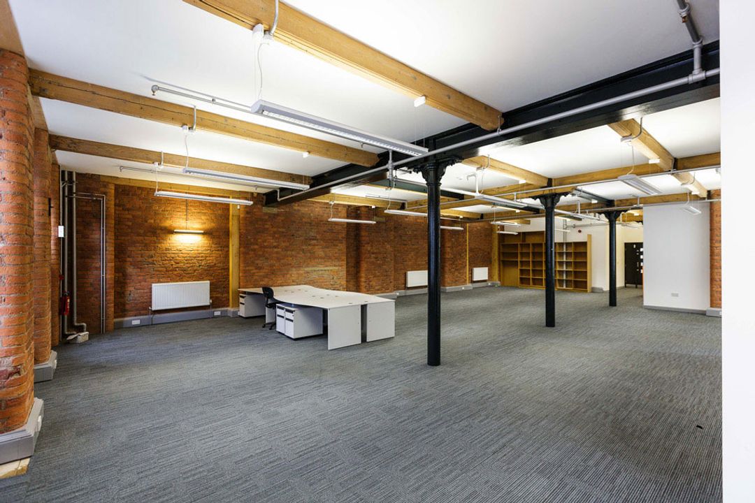 Buffalo 7 - Office space before fit out and furniture installation. Showing view of dark cast iron supports