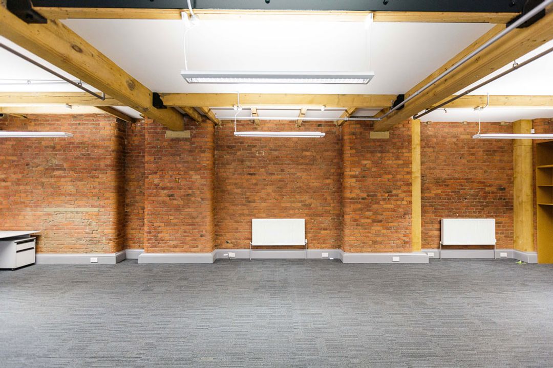 Buffalo 7 - Office space before fit out and furniture installation. Showing view of exposed brickwork and beams