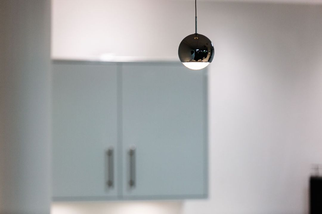 Polished chrome designer pendant lights hanging above the breakout bar at Premier Group, Manchester